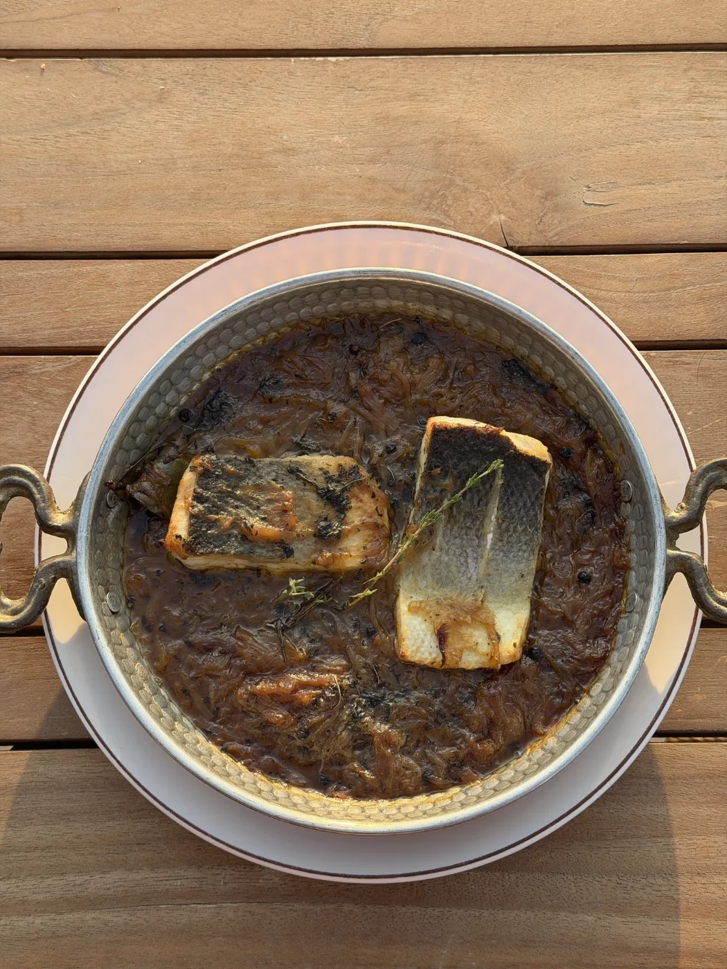 Tavë peshku with sea bass in the pan at Porto Vivo, fish restaurant above the sea in Durrës